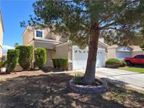 Inviting two-story home featuring a well-manicured front yard and a two-car garage at 3606 Gold Sluice Ave, North Las Vegas, NV 89032