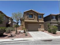 Attractive two-story home with a two-car garage, desert landscaping and tan stucco exterior at 3736 Gallowtree Ave, North Las Vegas, NV 89081