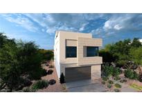 Modern two-story home with a two-car garage, gray brick accents, and low-maintenance desert landscaping at 3961 Heron Fairway Dr, Las Vegas, NV 89141
