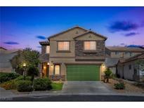 Charming two-story home featuring stone accents, a green garage door, and well-manicured landscaping at 4415 Peaceful Harbor St, Las Vegas, NV 89129