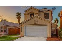 Two-story home featuring a front-facing two-car garage and desert landscaping at 6058 Grape Blossom Ave, Las Vegas, NV 89142