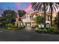 Stunning two-story home with lush landscaping and an elegant porte-cochere at 7 Rue Promenade Way, Henderson, NV 89011