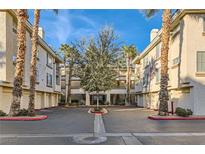 Inviting condo complex with lush landscaping, palm trees, and well-maintained buildings in a desirable location at 7127 S Durango Dr # 310, Las Vegas, NV 89113