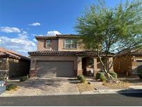 Charming two-story home featuring a brick driveway and a well-manicured front yard at 777 Star Apple Ln, Las Vegas, NV 89178