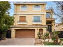 Two-story home with a two-car garage and a well-maintained, inviting front yard with decorative stonework at 8467 Bismark Sapphire St, Las Vegas, NV 89139