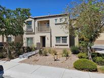 Charming two-story home with a balcony, desert landscaping, and sidewalk appeal at 8865 Knickknack Ct, Las Vegas, NV 89149