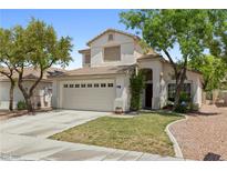 Charming two-story home featuring a well-maintained lawn and two-car garage at 981 Leadville Meadows Dr, Henderson, NV 89052