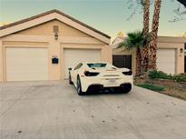 Charming home featuring a private driveway leading to garages with palm trees along the side at 1006 Bel Air Cir, Las Vegas, NV 89109