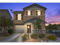 Charming two-story home features desert landscaping, a covered porch, and a two car garage at 106 Basketflower Ct, Las Vegas, NV 89183