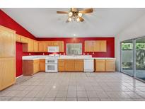 Bright kitchen featuring light wood cabinets and tiled floor at 1230 Pagentry Dr, North Las Vegas, NV 89031