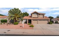 Two-story home featuring a terracotta roof, desert landscaping, and a two-car garage at 1587 Bermuda Dunes Dr, Boulder City, NV 89005
