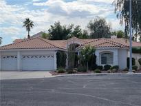 Charming single-story home featuring a three-car garage, well-manicured landscaping, and a classic tile roof at 175 Palta Ct, Henderson, NV 89074