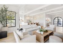Bright and airy living room with modern furniture, large windows, and hardwood floors at 1990 Country Cove Ct, Las Vegas, NV 89135
