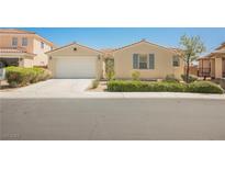Charming single-story home featuring a two-car garage, desert landscaping, and a neutral color palette at 2008 Royal Gardens Pl, North Las Vegas, NV 89084