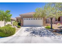 Charming single-story home with a two-car garage, desert landscaping, and a beautiful stone facade at 2616 Red Planet St, Henderson, NV 89044