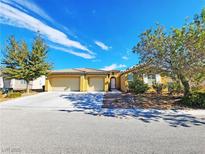 Charming single-story home featuring a three-car garage, desert landscaping, and a tile roof at 3829 N Mayfield Ranch Rd, Pahrump, NV 89060