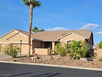 Charming single-story home with a three-car garage, desert landscaping, and a well-maintained yard at 4016 Mountain Trek St, Las Vegas, NV 89129