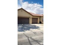 Charming home featuring a three-car garage and well-maintained exterior at 5004 Wayfaring Tree Ave, Las Vegas, NV 89131