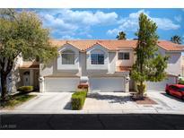 Charming townhome featuring an attached garage and well-maintained landscaping at 5256 Harvest Breeze Rd, Las Vegas, NV 89118