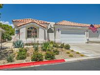 Charming single-story home with a well-maintained xeriscaped yard and a red tile roof at 5489 Royal Vista Ln, Las Vegas, NV 89149