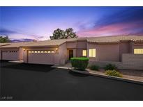 Inviting single-story home featuring a well-manicured lawn, attached garage, and charming curb appeal at 615 Cervantes Dr, Henderson, NV 89014