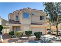 Inviting two-story home featuring a two-car garage and well-maintained landscaping at 6241 Overhang Ave, Henderson, NV 89011