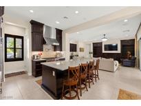 Open kitchen featuring an island with bar seating, modern appliances, and dark cabinetry at 6810 Silver Crescent St, Las Vegas, NV 89148