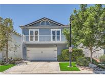 Charming blue two-story home featuring a garage and a balcony at 8713 Nautical Bay Ln, Las Vegas, NV 89117