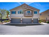 Charming two-story home featuring three-car garage, complemented by stucco facade and balcony detail at 10062 Aspen Rose St # 103, Las Vegas, NV 89183