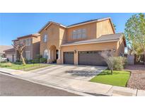Two-story home featuring a two-car garage, neutral stucco, and a tile roof, complemented by neat landscaping at 10654 Sidlaw Hills Ct, Las Vegas, NV 89141