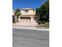 Charming two-story home featuring a spacious driveway and a well-maintained lawn with mature landscaping at 2320 Angelfire St, Las Vegas, NV 89128