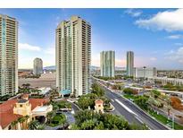 Striking aerial view of luxury high-rise condos, beautiful landscaping, and Las Vegas skyline against a blue sky at 2777 Paradise Rd # 1002, Las Vegas, NV 89109