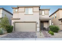 Charming two-story home with a welcoming front porch and a well-maintained lawn and a large garage at 4178 Eagle Island St, Las Vegas, NV 89130