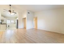 Bright living room with hardwood floors and an open floor plan to the kitchen at 4274 Rollingstone Dr, Las Vegas, NV 89103