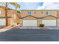 Two-story townhome featuring attached garages and desert landscaping for a low-maintenance appeal at 5249 Wave Dancer Ln, Las Vegas, NV 89118