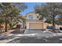 Charming two-story home featuring a beige exterior, two-car garage, and mature landscaping with shade trees at 5636 Royal Castle Ln, Las Vegas, NV 89130
