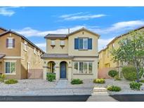 Charming two-story home with desert landscaping, blue door and shutter accents under a beautiful sunny sky at 5717 Heineken Dr, North Las Vegas, NV 89031