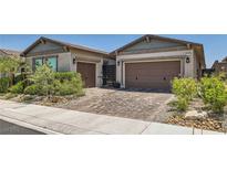 Beautiful single-Gathering home featuring a meticulously landscaped front yard and a paved driveway leading to two-car garages at 704 Webber Park St, Henderson, NV 89011