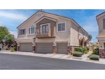 A townhome featuring desert landscaping and a multi-car garage in a well-maintained community at 7120 Bear Paw Creek St # 101, Las Vegas, NV 89149