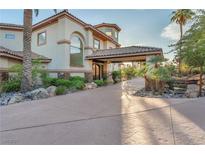 Stunning stucco home featuring mature landscaping and a porte cochere on a concrete driveway at 743 N Orleans St, Henderson, NV 89015