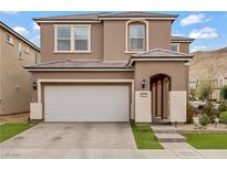Two-story home features a front yard, two-car garage, and desert landscaping at 9557 Belmont Bay Ave, Las Vegas, NV 89148