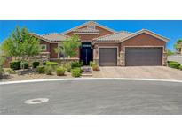 Charming home featuring a tile roof, stone accents, mature landscaping and a three-car garage at 334 Cougar Estates Ln, Las Vegas, NV 89123
