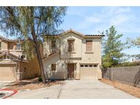 Charming two-story home with a one-car garage and a well-maintained front yard at 10253 Martinsburg Ct, Las Vegas, NV 89183