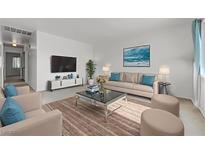 Bright living room with neutral tones, comfortable seating, and a modern entertainment center at 1101 Willow Tree Dr # D, Las Vegas, NV 89128