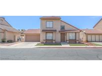 Inviting two-story home featuring a well-maintained lawn and attached two-car garage at 2711 Sesame Dr, Las Vegas, NV 89142