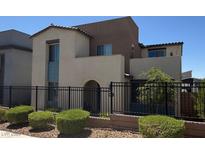 Modern two-story home with black fence, desert landscaping, and stucco exterior at 3369 Ponicelli Ln, Henderson, NV 89044