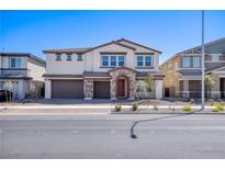 Charming two-story home featuring a stone-accented entrance, a 3 car garage and a well-maintained yard at 425 Canary Song Dr, Henderson, NV 89011