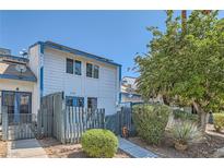 Charming two-story townhome with a quaint fenced yard and mature landscaping at 4259 Kona Coast Way, Las Vegas, NV 89121