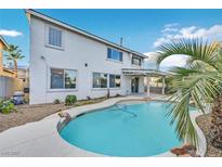 Backyard pool with a covered patio and lush landscaping, creating a private outdoor oasis at 600 Baysville Ct, Las Vegas, NV 89144