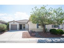 Charming single-story home with a well-maintained front yard and two-car garage on a sunny day at 6333 Sterling Ranch Way, North Las Vegas, NV 89081